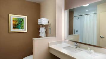 Un baño moderno con un lavamanos blanco, un espejo grande, una cortina de ducha y un cuadro en la pared.