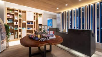 A modern interior with wooden shelves, a reception desk, and a decorative table.