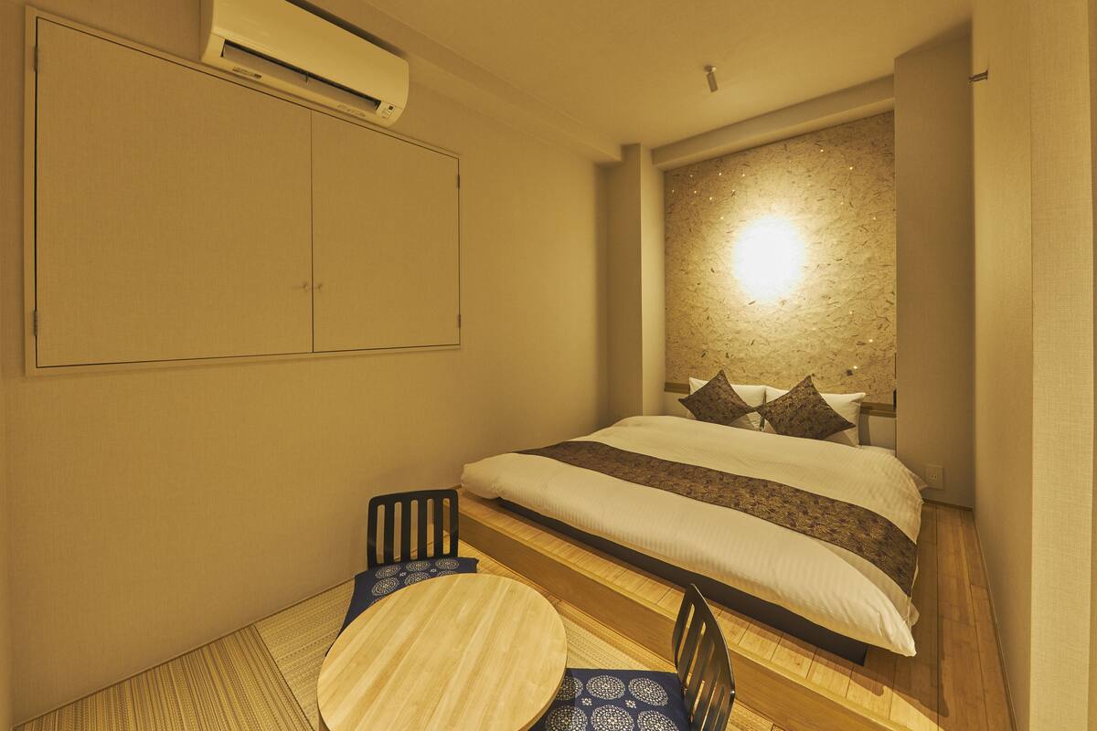 Une chambre à coucher avec un lit, une table et des chaises.
