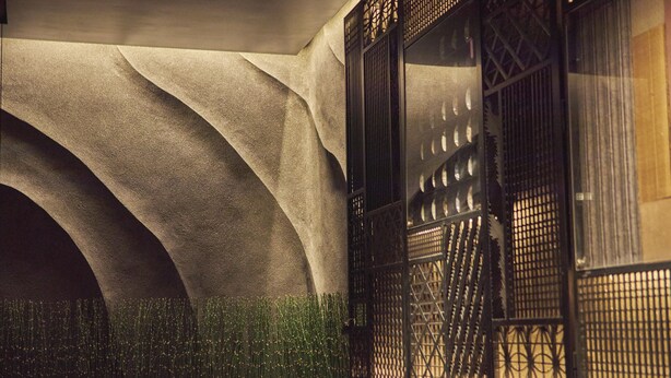A building with a modern architectural design, featuring a large arched entrance and a decorative metal gate. - SAKE Kura Hotel Kawasaki Shuku (Kawasaki)