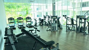 A gym with cardio machines, weight benches, and free weights. - Sri Beverly Hills Near KLIA & KLIA2 & F1 (Nilai)