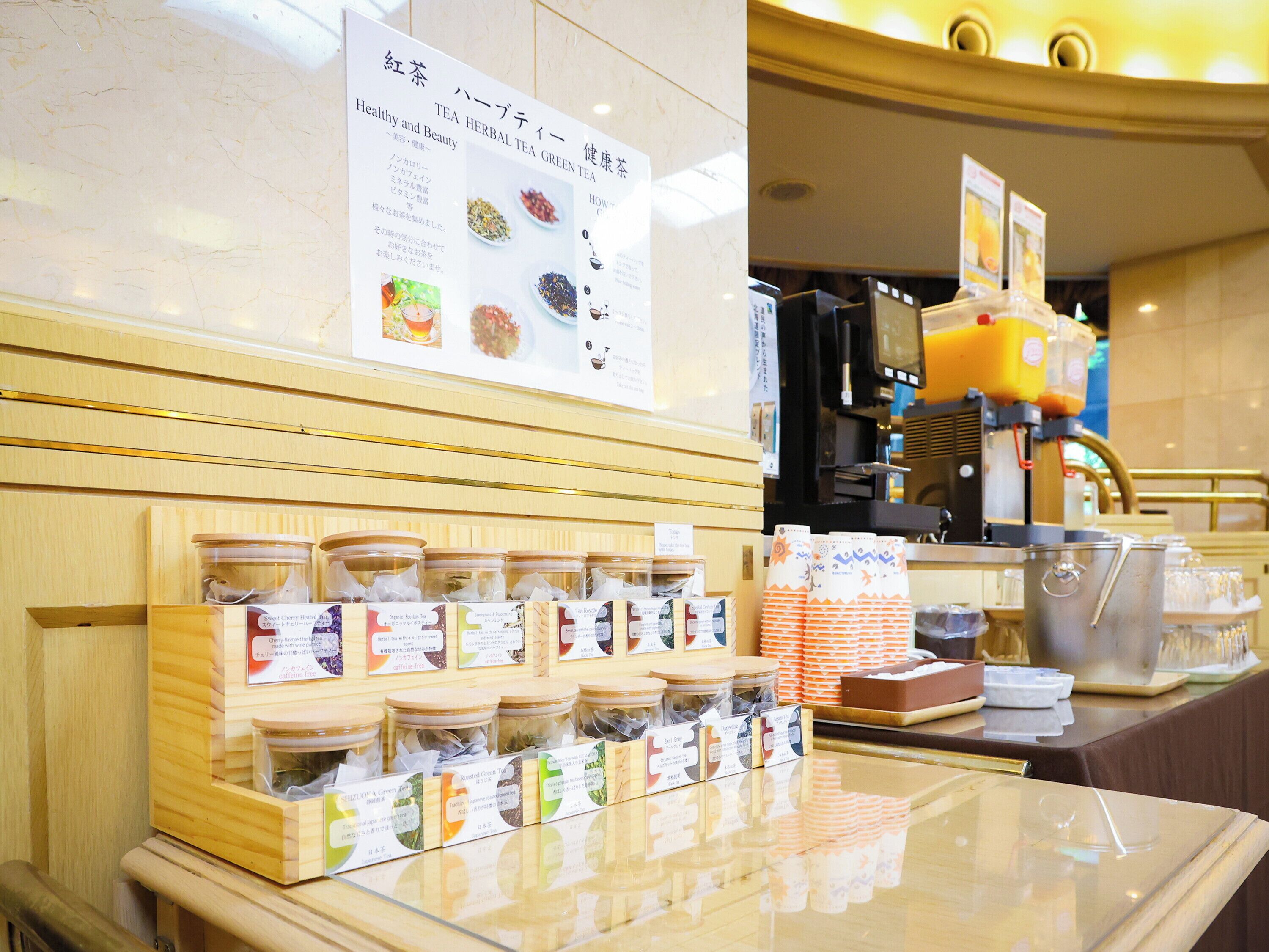 A tea shop interior with a display of tea products and a coffee machine.