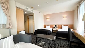 A hotel room with two beds, a desk, a chair, a small table, and a bathroom door. - APA Hotel TKP Sapporoeki-Kitaguchi EXCELLENT (Sapporo)
