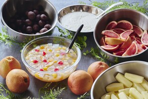A variety of fruits and a bowl of fruit salad with a spoon. - Hakodate Hotel Banso(ORIX HOTELS & RESORTS) (Hakodate)