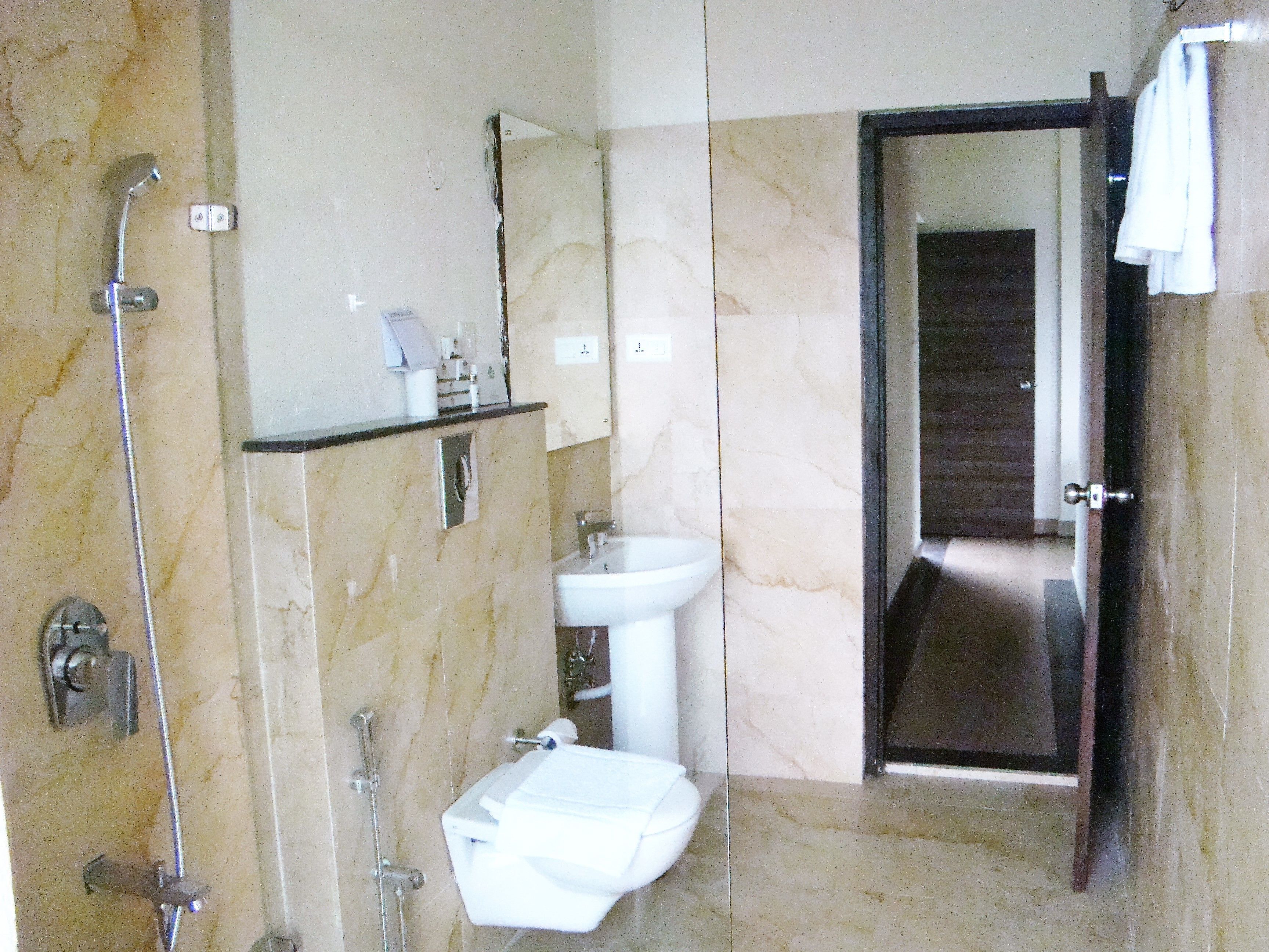 A bathroom with a shower, sink, and toilet.