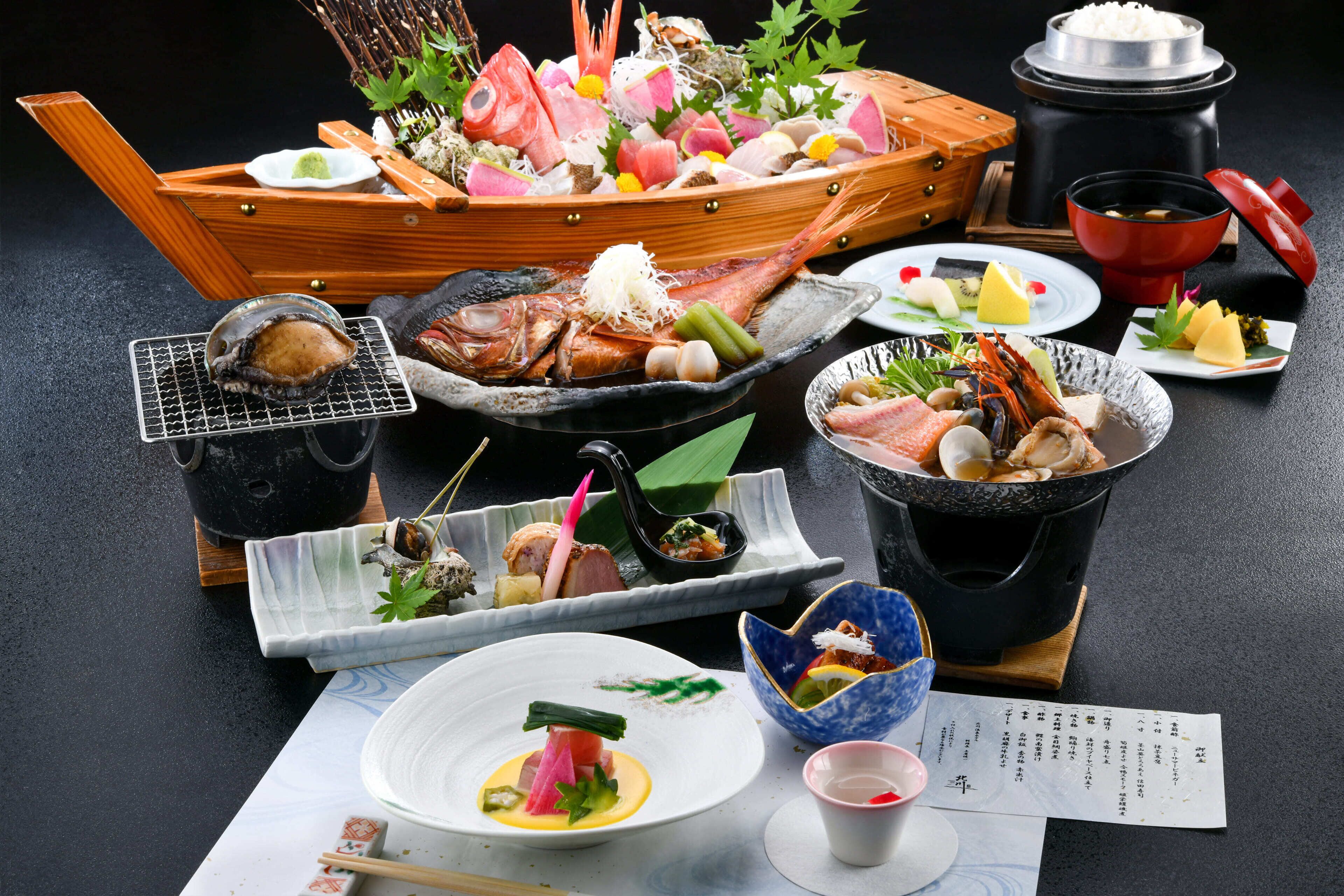 A variety of seafood dishes on a table, including fish, shrimp, and other seafood items.