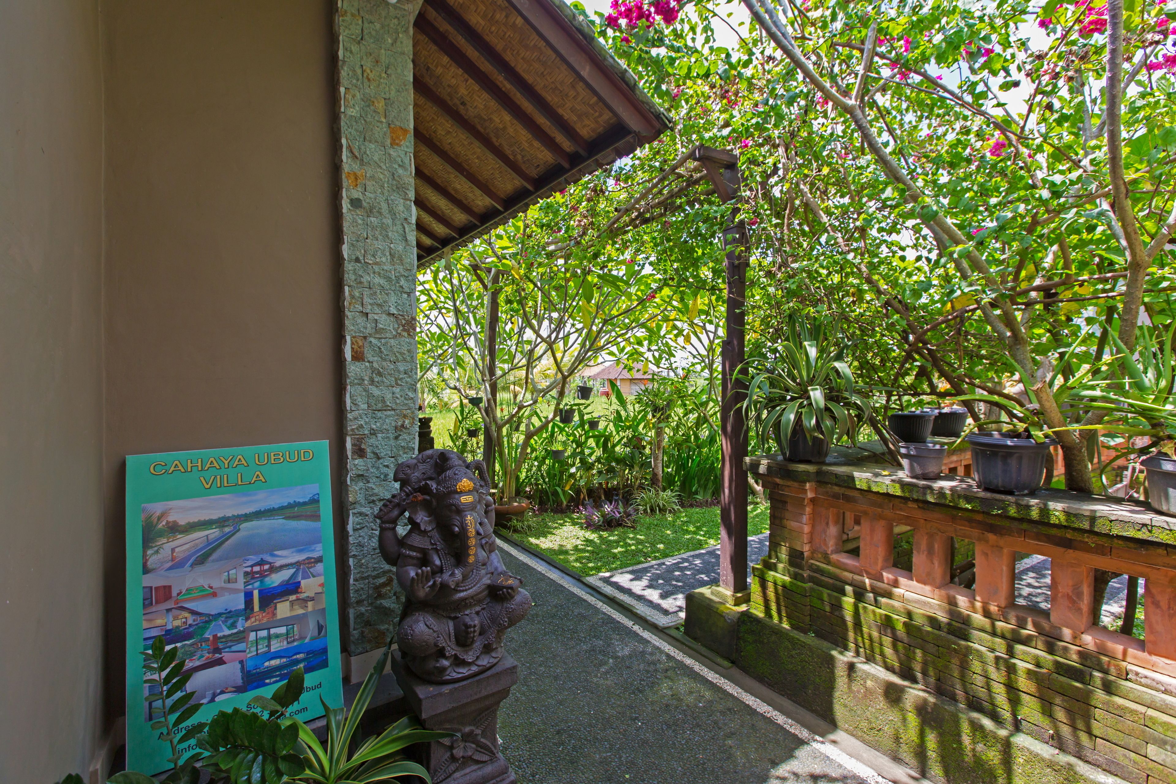 A pathway leading to a building with a signboard titled "CAHAYA UBUD VILLA".