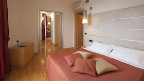 A hotel room with a large bed, a bedside table, a wardrobe, and a mirror. - AlbaResidence masera26 (Alba)