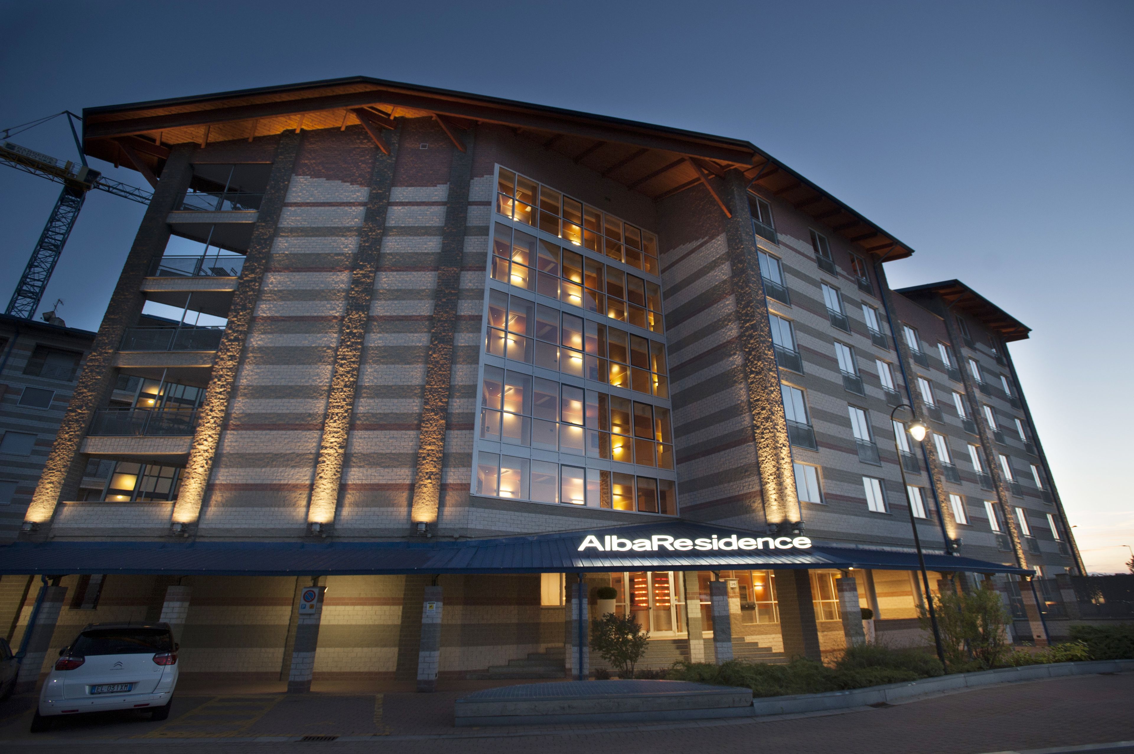 A multi-story hotel with a prominent entrance and illuminated windows.