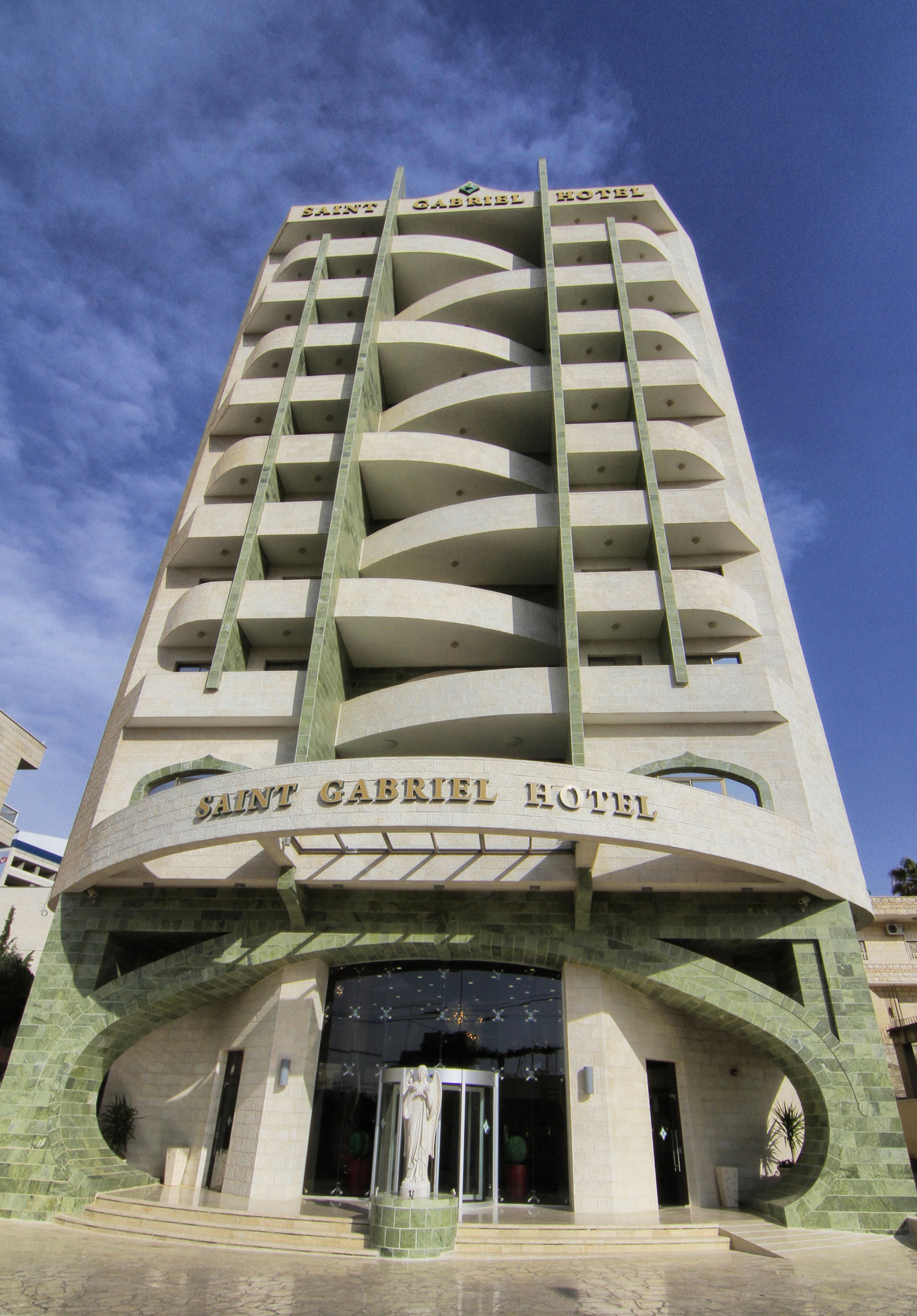 A tall building with the name "SAINT GABRIEL HOTEL" on the facade.