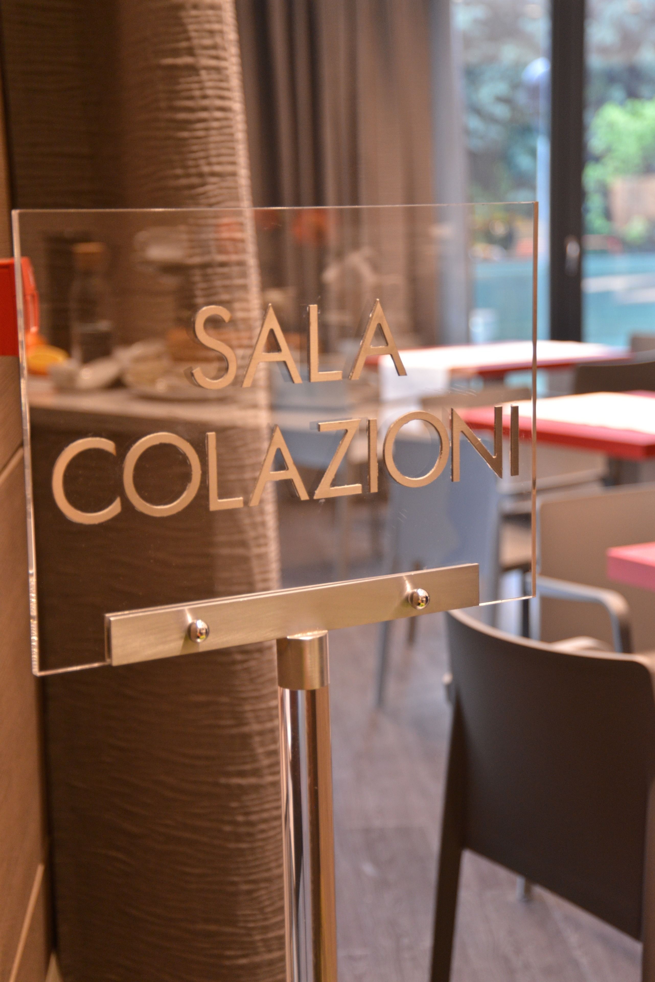 A clear sign with the words "SALA COLAZIONI" indicating a specific room or area within a building.