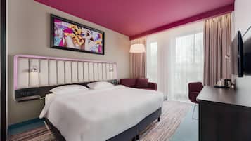 A hotel room with a large bed, a desk, a TV, a painting on the wall, and a window with curtains.