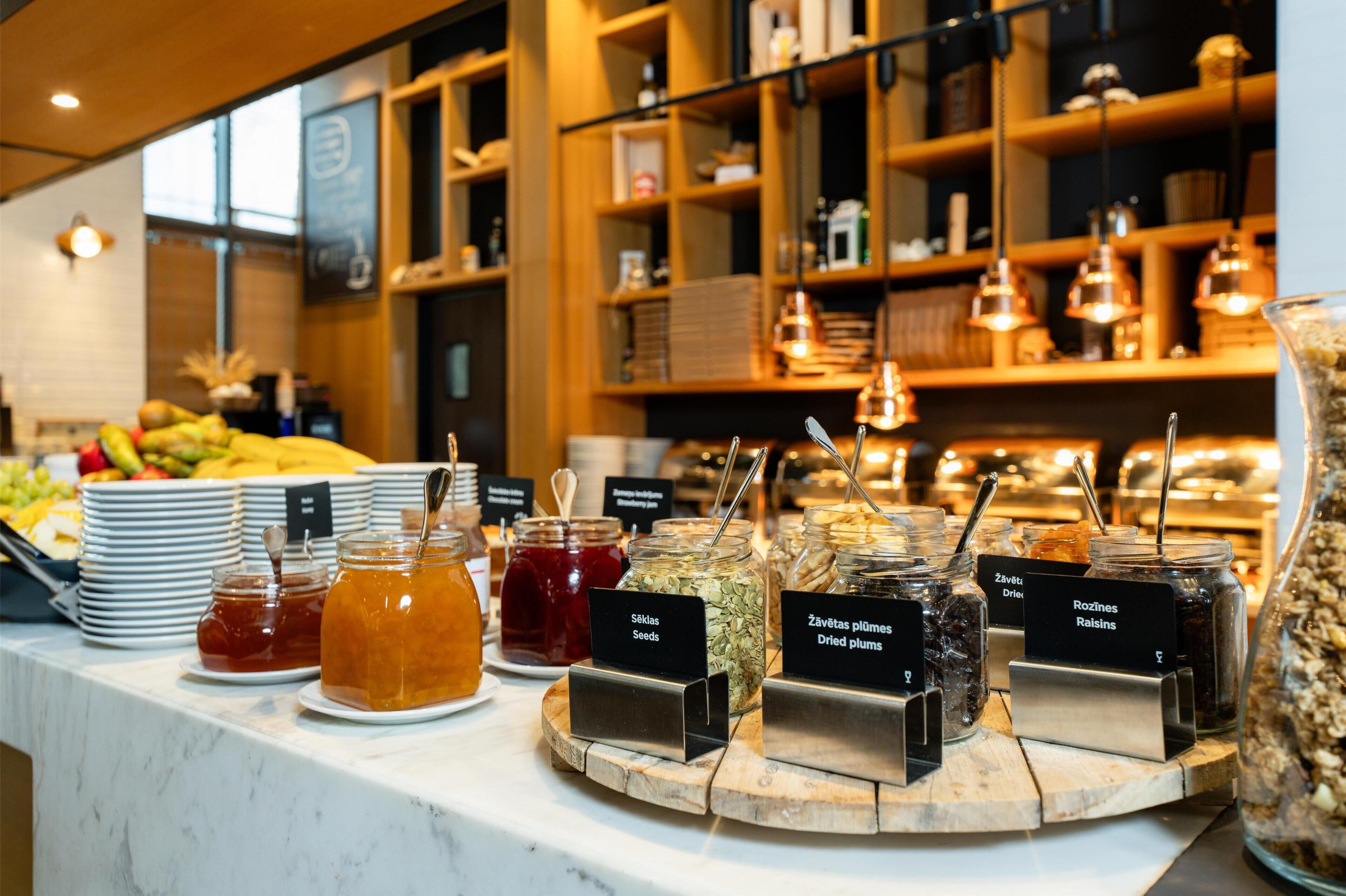 A buffet with various food items and condiments.
