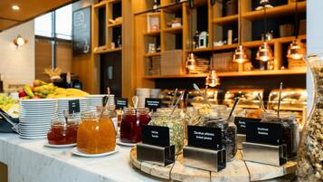 A buffet with various food items and condiments.