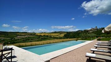Seasonal outdoor pool, an infinity pool, pool umbrellas, pool loungers