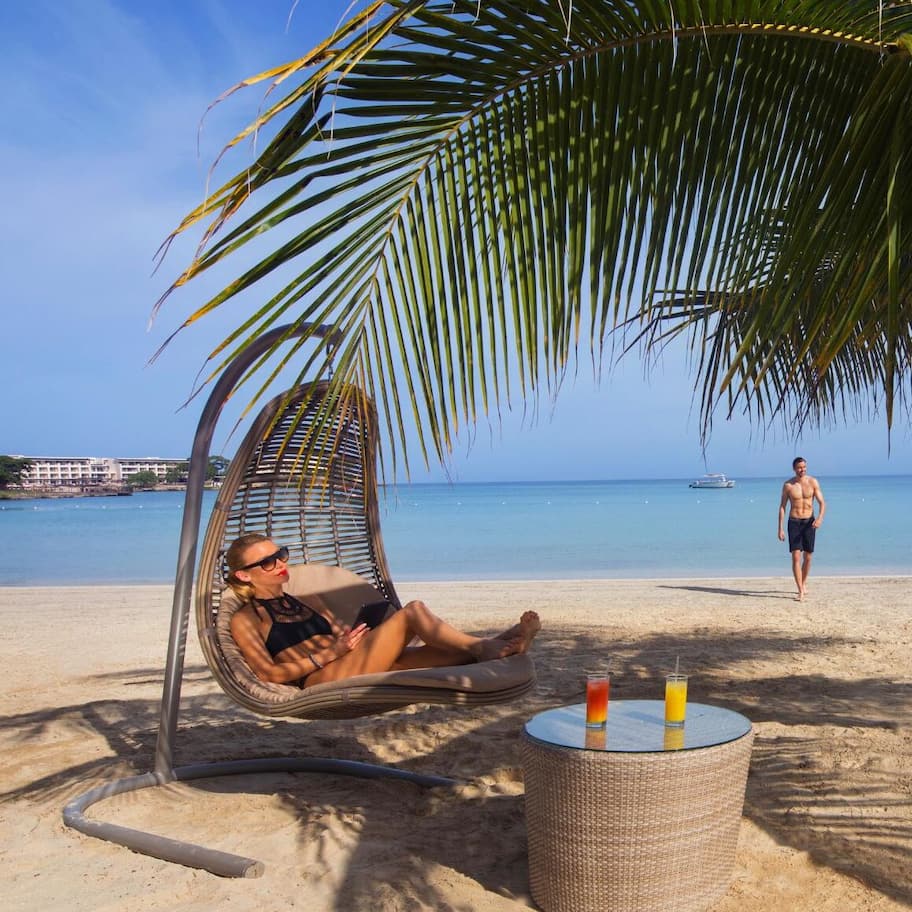On the beach, white sand, sun loungers, beach umbrellas