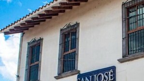 A building with a sign reading "SAN JOSE" and a tiled roof.