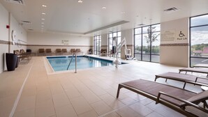 A pool area with a pool lift, lounge chairs, and a view of the outdoors. - Hampton Inn Morristown, I-81 (Morristown)