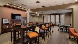 A conference room with a long table, multiple chairs, a television, and framed pictures on the walls. - Hampton Inn Morristown, I-81 (Morristown)