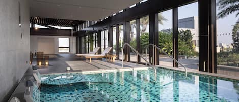 Indoor pool, open 7:00 AM to 10:00 PM, pool loungers, lifeguards on site