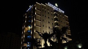 A multi-story hotel with a prominent 'Golden' sign, indicating it is a luxury establishment. - Golden Tulip Al Khobar Suites (Al Khobar)