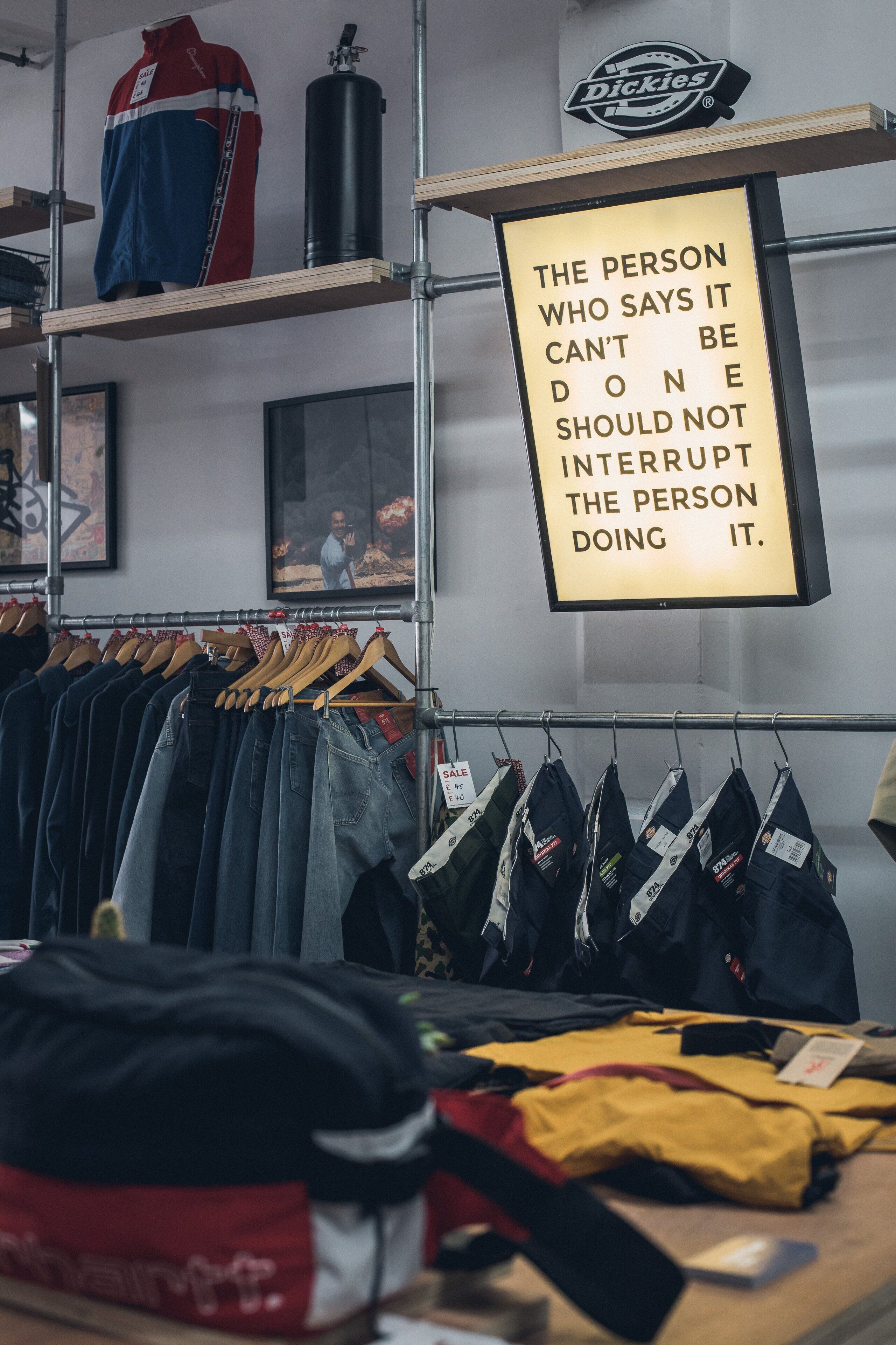 A clothing store with jeans and jackets on display.