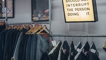 A clothing store with jeans and jackets on display.