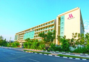 A multi-story hotel with a modern design, featuring a prominent logo on the facade. - Kigali Marriott Hotel (Kigali)