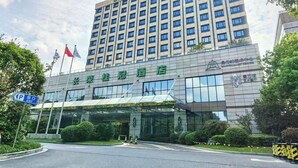 A hotel with a modern glass facade, multiple floors, and a prominent sign. - Evergreen Laurel Hotel Shanghai (Shanghai)