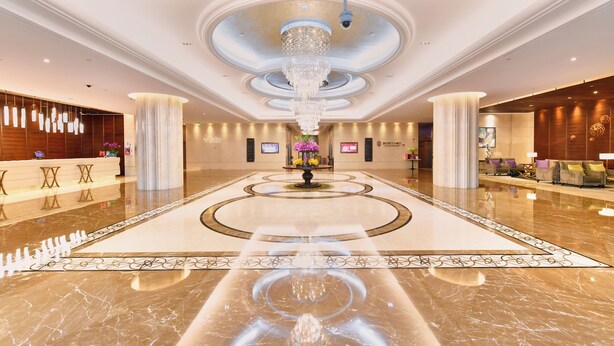 A spacious lobby with a central fountain, marble flooring, and a reception desk. - Evergreen Laurel Hotel Shanghai (Shanghai)