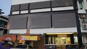 A multi-story building with commercial spaces on the ground floor, including a restaurant and a One Point store. - One Point Hotel - RH Plaza (Kuching)