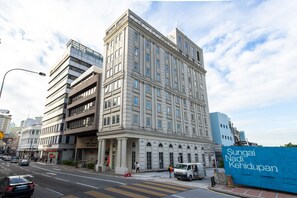 A multi-story building with a classical architectural style, featuring a prominent entrance with columns and a large glass facade. - Avenue J Hotel Central Market KL (Kuala Lumpur)