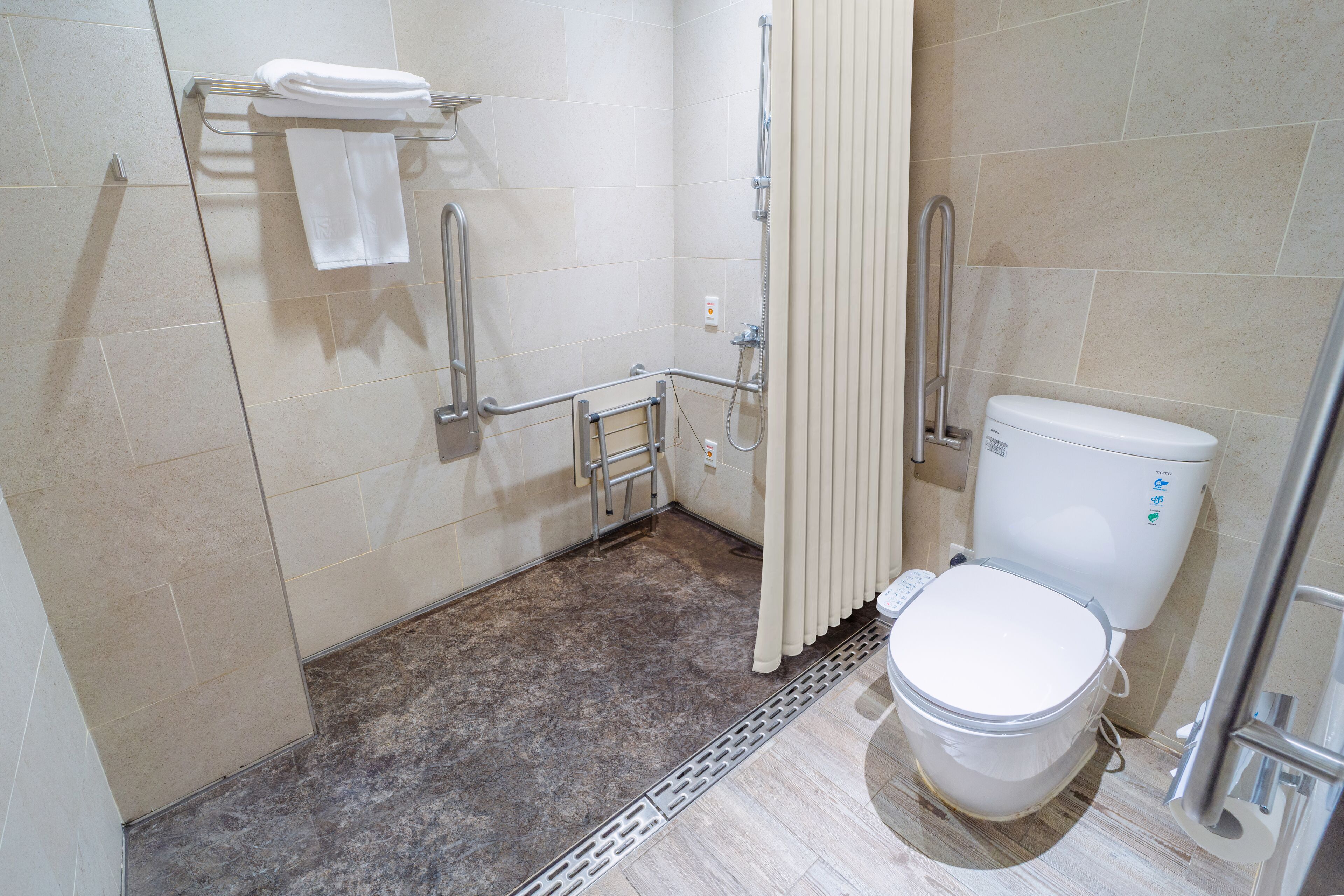 explore accessible | bathroom | shower, hair dryer, electronic bidet, towels