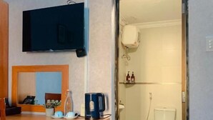 A bathroom with a toilet, a sink, and a mirror. - Amy Hostel Hue (Hue)