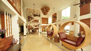 A spacious lobby with a high ceiling, a central staircase, and a large wicker sofa. - My Chiang Mai Boutique Lodge (Chiang Mai)