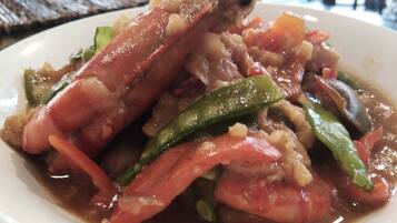 A plate of cooked seafood with vegetables.