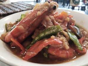 A plate of cooked seafood with vegetables.