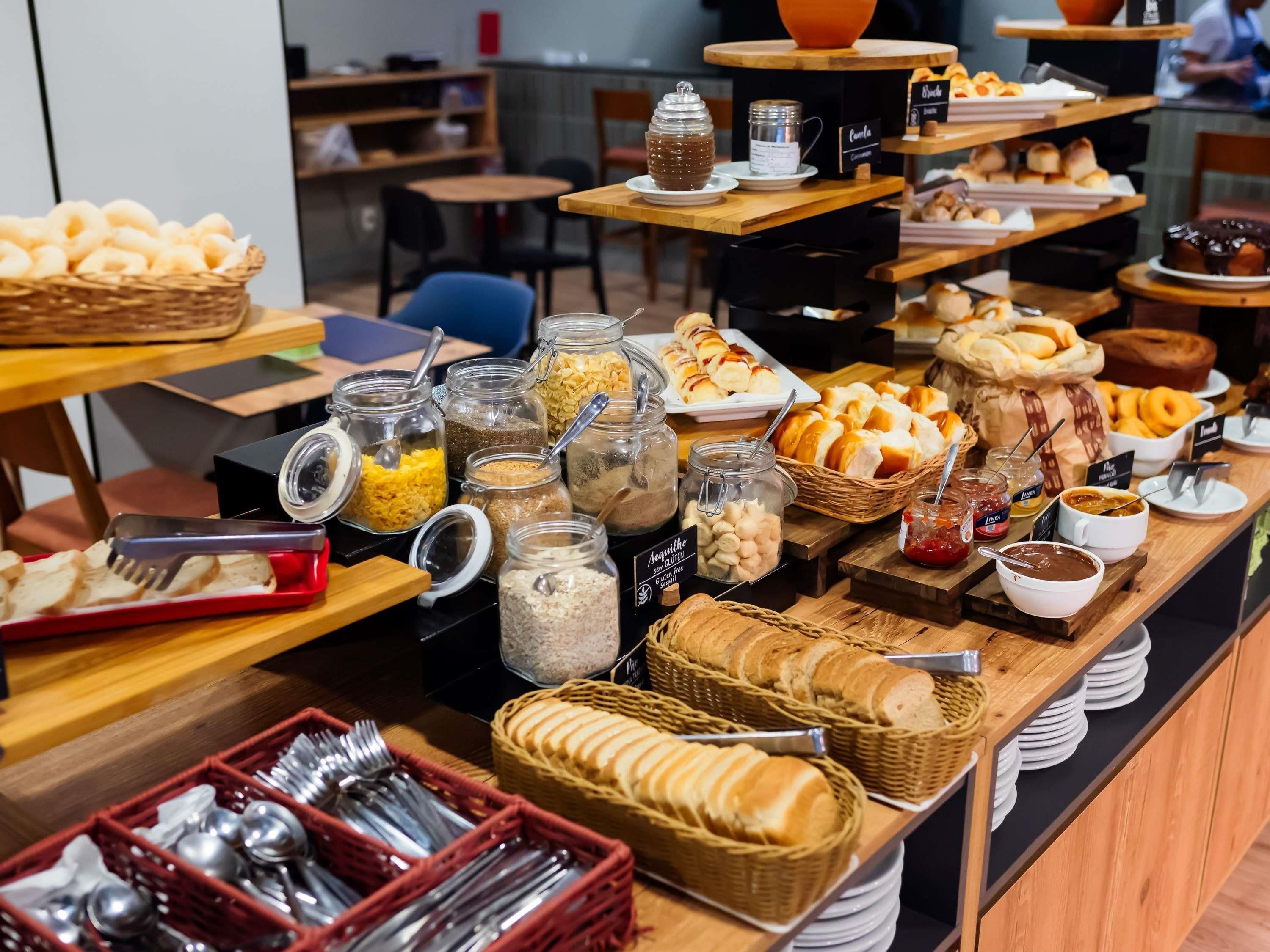 A buffet with various food items and condiments.