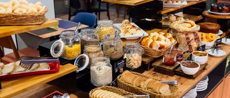 A buffet with various food items and condiments.