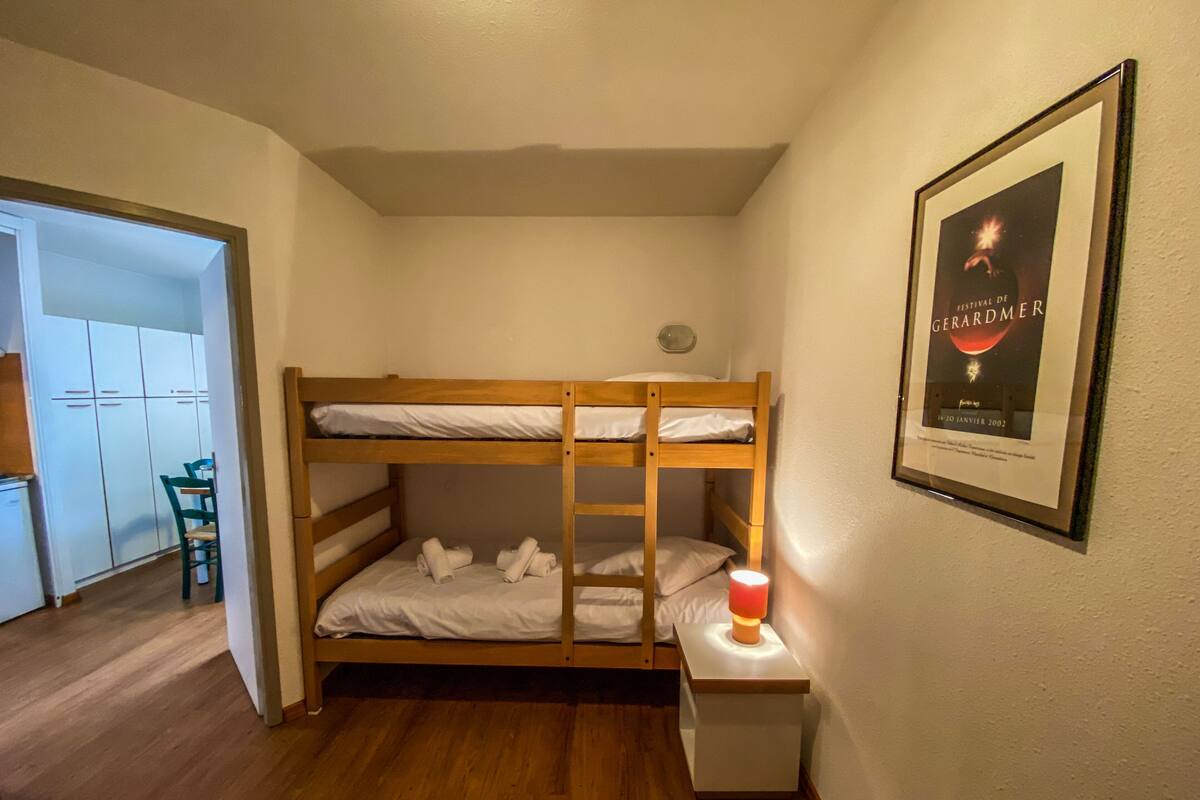 A bunk bed room with a framed poster on the wall.