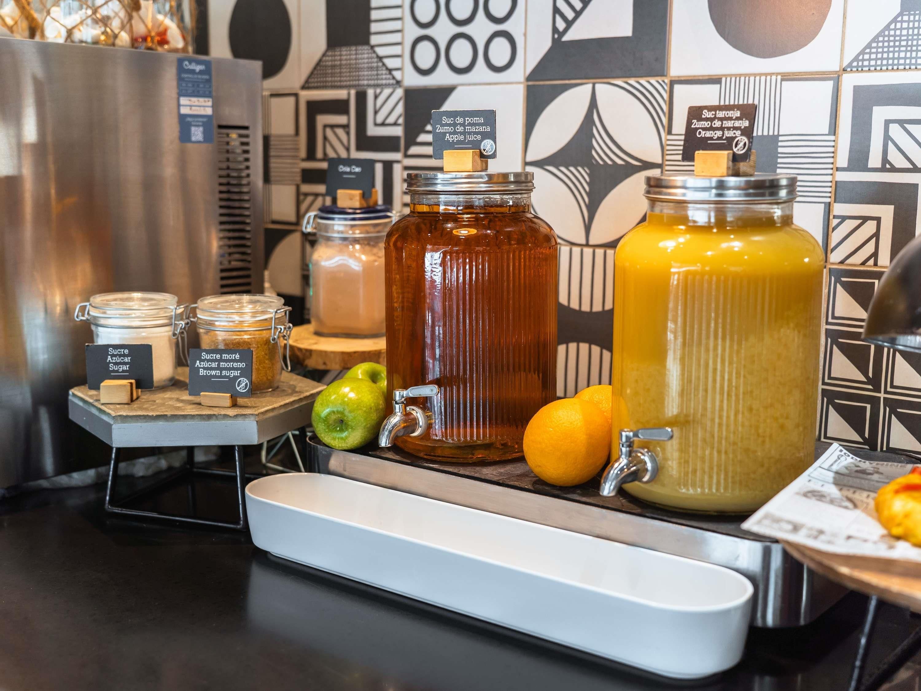 A juice station with various types of sugar and syrups, including apple, orange, and brown sugar.