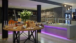 A breakfast buffet with a variety of food items and a decorative guitar. - Hard Rock Hotel Davos (Davos)
