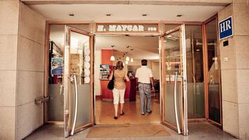 The entrance to H. Maycar with a glass door and a visible HR sign.