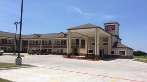 A multi-story Express Inn hotel with a covered entrance and a parking lot. - Express Inn (Wharton)
