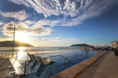 Outdoor pool, open 9:00 AM to 9:00 PM, pool loungers. Holiday Inn Resort Mazatlan by IHG