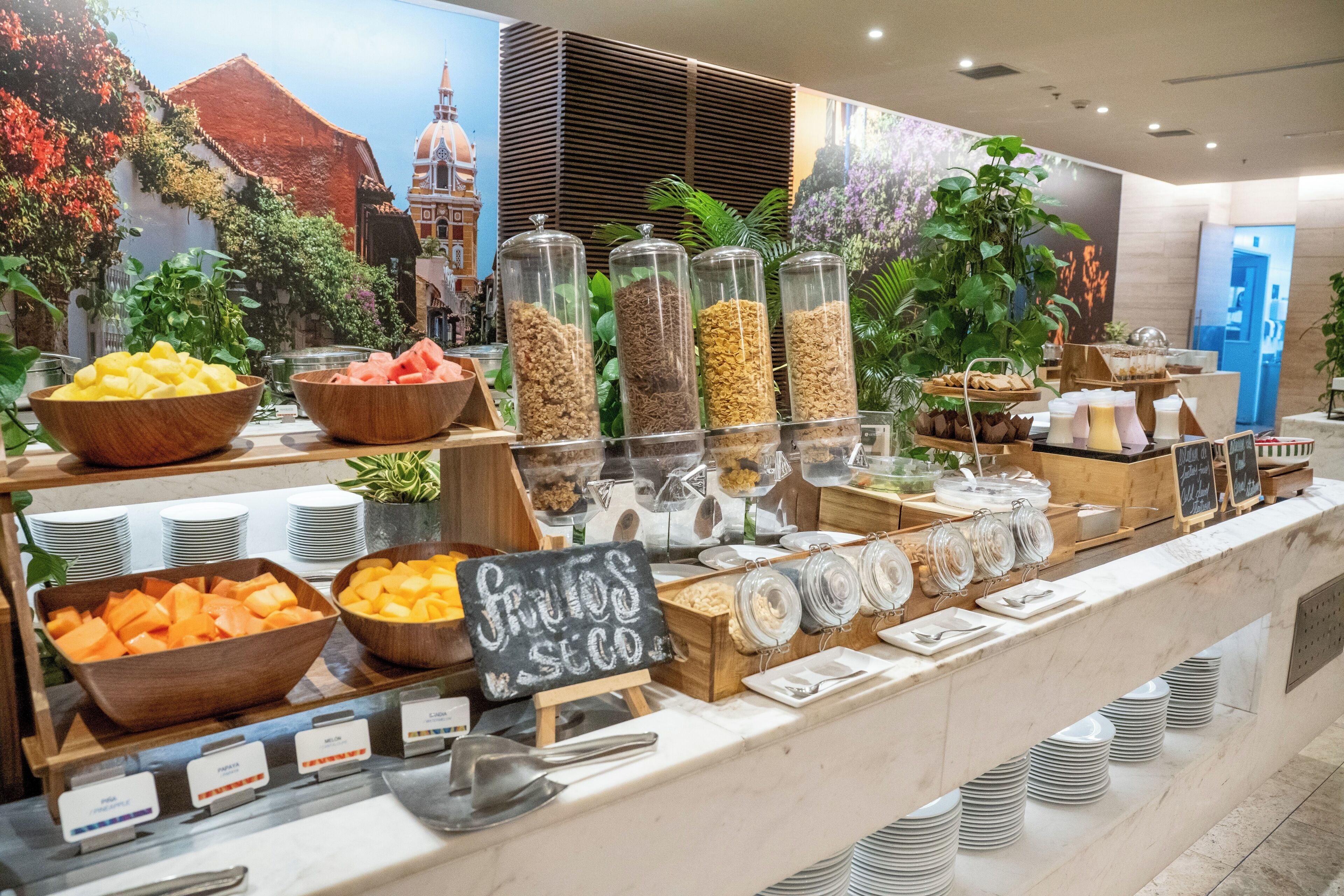 A breakfast buffet with various food items and a chalkboard sign.