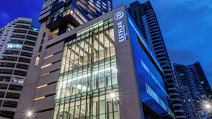 A modern hotel building with a prominent glass facade and a visible sign reading "ESTELAR."