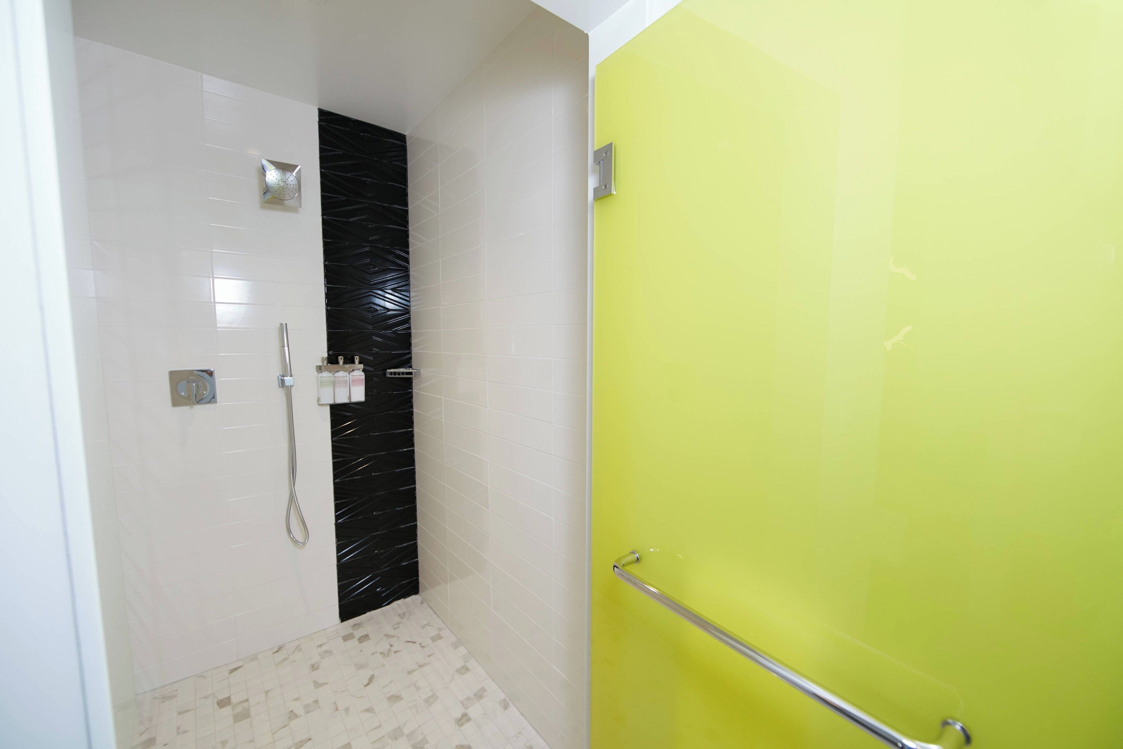A bathroom with a shower, a toilet, and a sink.