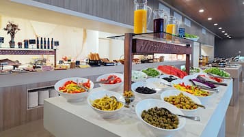 A buffet with various food items and beverages.