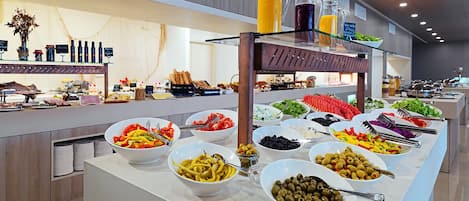 A buffet with various food items and beverages.